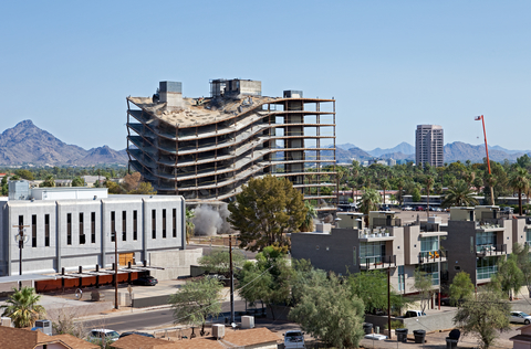 Building coming down, after series of explosions