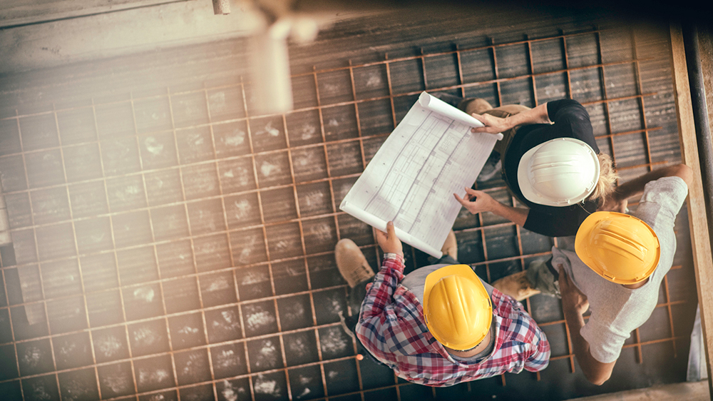 demolition workers looking at blueprints 